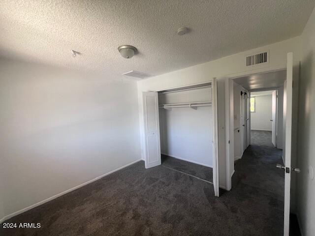 4332 W Ocotillo Rd Unit 206, Glendale, AZ 85301 - unfurnished bedroom with carpet flooring, a closet, and a textured ceiling