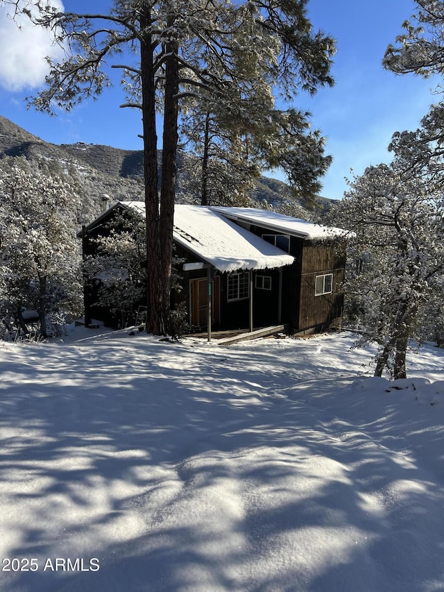 snow covered property featuring a mountain view