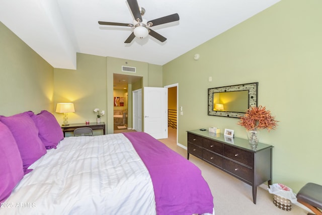 bedroom featuring ceiling fan, ensuite bathroom, and light carpet