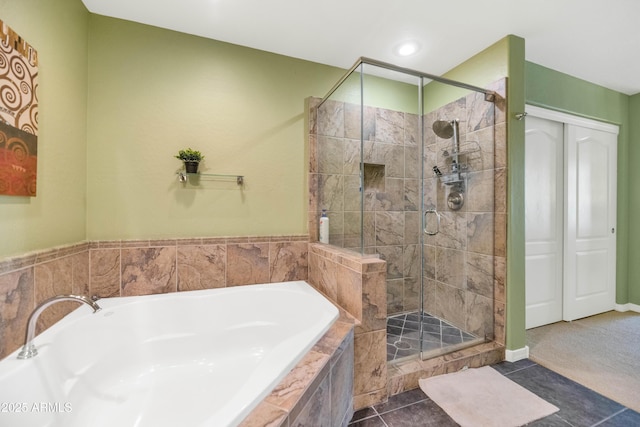 bathroom with tile patterned flooring and separate shower and tub