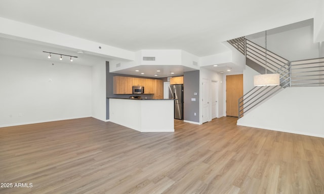 unfurnished living room featuring light hardwood / wood-style floors