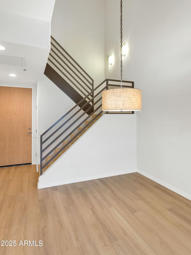 staircase with hardwood / wood-style floors