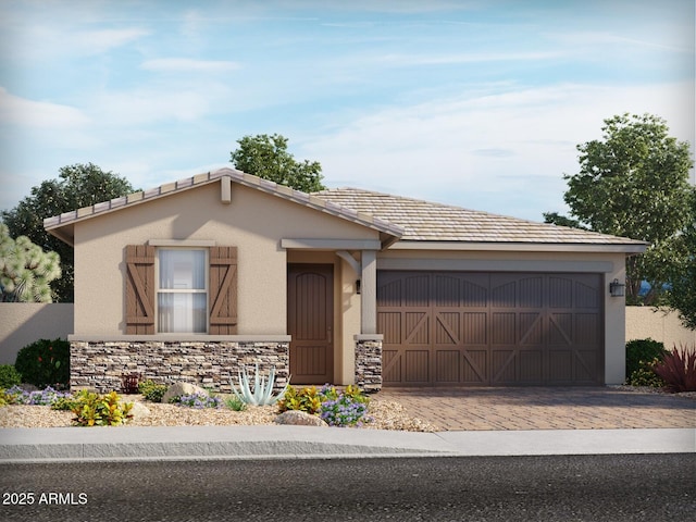 view of front facade featuring an attached garage, stone siding, decorative driveway, and stucco siding