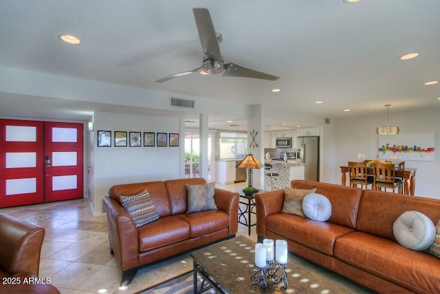 living room featuring french doors and light tile patterned flooring