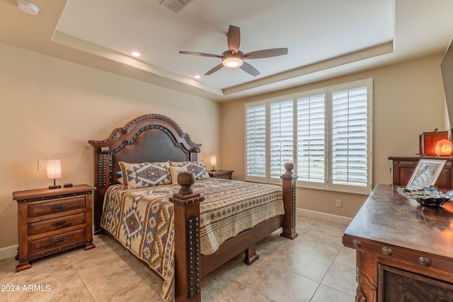 bedroom featuring a tray ceiling, light tile patterned flooring, baseboards, recessed lighting, and a ceiling fan
