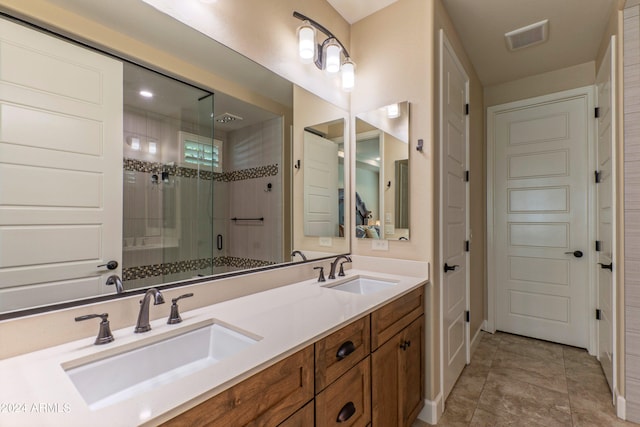 bathroom with visible vents, a sink, double vanity, and a stall shower