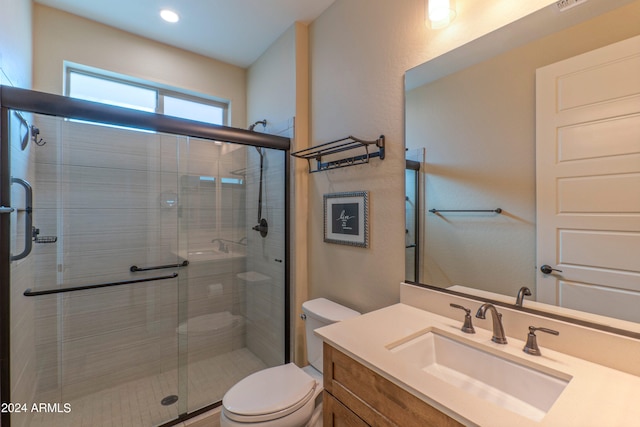 bathroom with recessed lighting, vanity, toilet, and a stall shower
