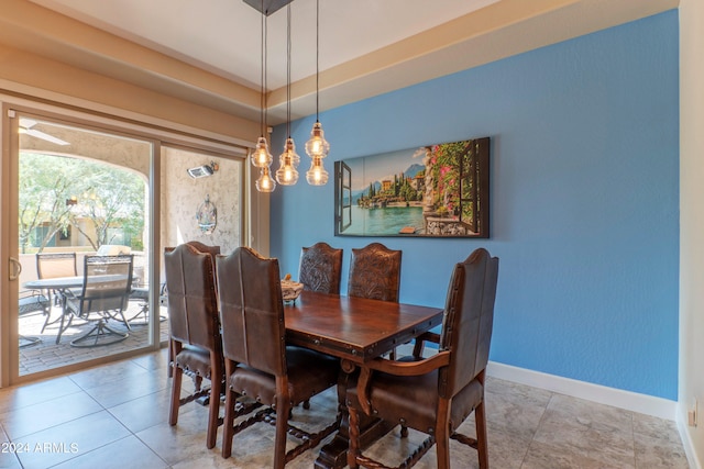 dining room featuring baseboards and light tile patterned flooring