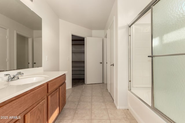 bathroom with vanity, combined bath / shower with glass door, and tile patterned flooring