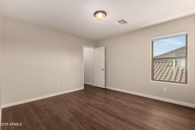 unfurnished room featuring dark hardwood / wood-style floors