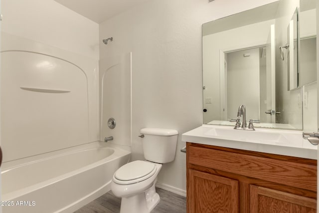 full bathroom with vanity, wood-type flooring, bathtub / shower combination, and toilet