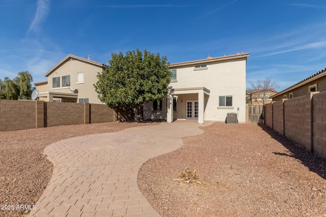 rear view of property with a patio and central air condition unit