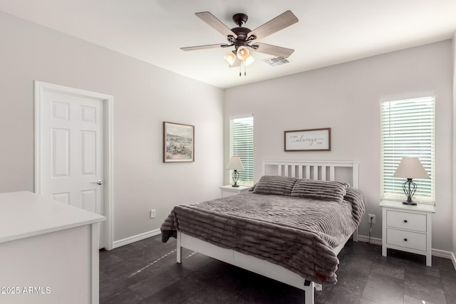 bedroom featuring multiple windows and ceiling fan