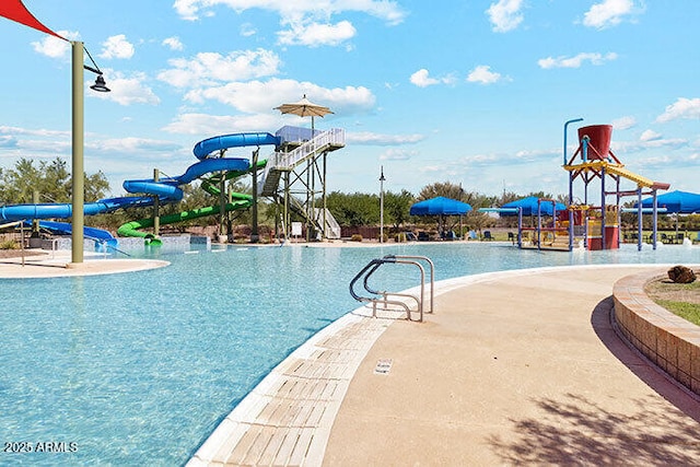 view of pool featuring a playground