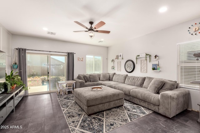 living room with dark hardwood / wood-style floors and ceiling fan