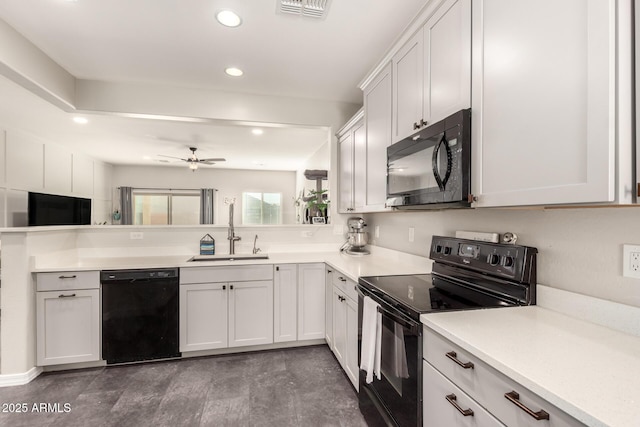 kitchen featuring black appliances, white cabinetry, sink, ceiling fan, and kitchen peninsula