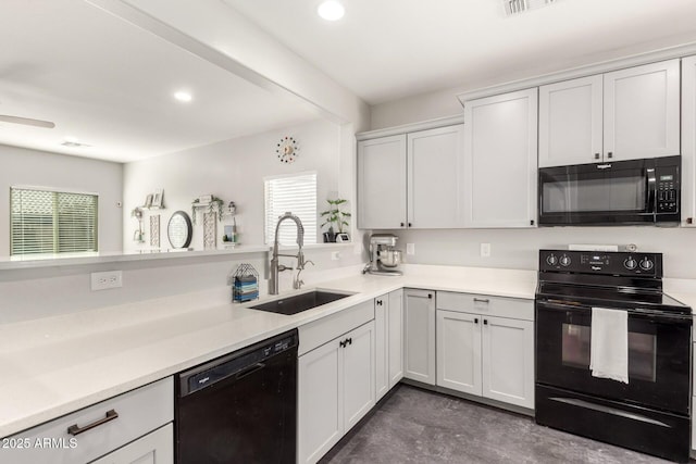 kitchen with sink, black appliances, and white cabinets