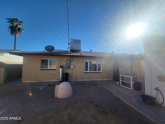 rear view of house featuring a patio area and central air condition unit