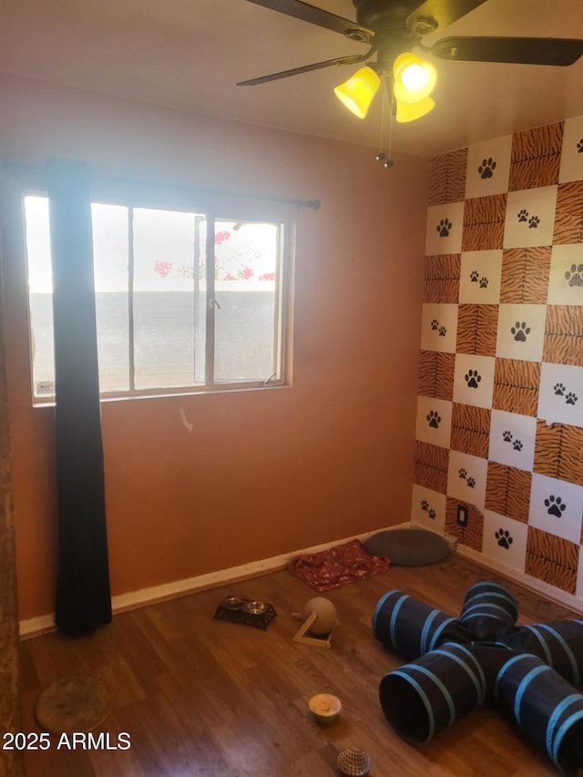 interior space featuring ceiling fan and wood-type flooring