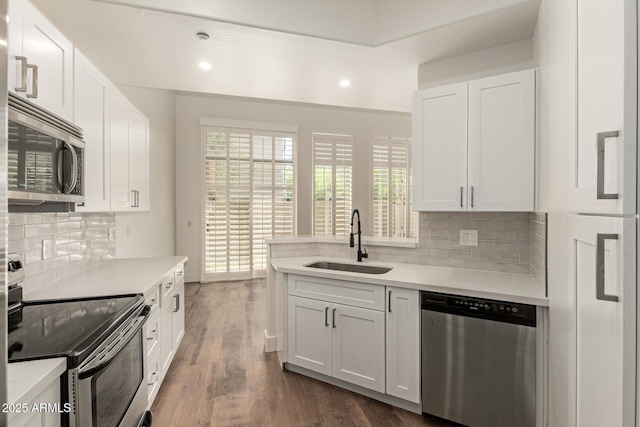 2019 E Campbell Ave Unit 110, Phoenix, AZ 85016 - kitchen with stainless steel appliances, a sink, light countertops, tasteful backsplash, and recessed lighting