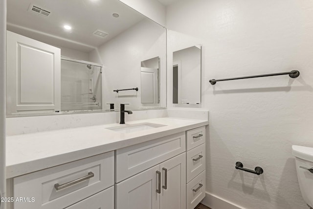 2019 E Campbell Ave Unit 110, Phoenix, AZ 85016 - bathroom featuring toilet, vanity, and an enclosed shower