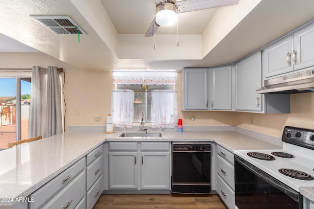 kitchen with dark wood-type flooring, black dishwasher, ceiling fan, white range with electric stovetop, and sink