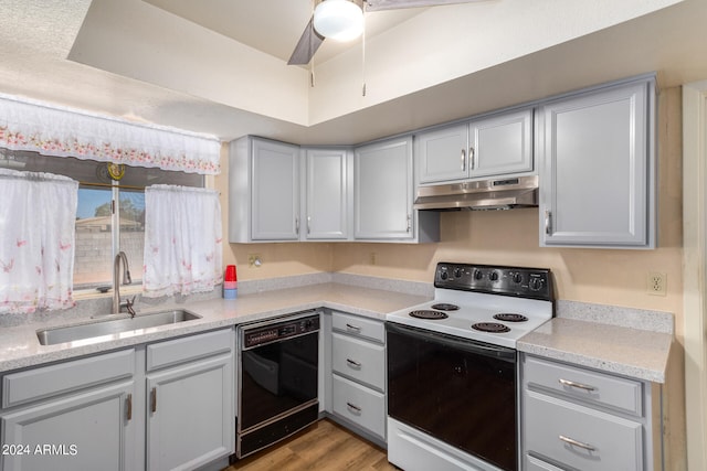 kitchen featuring dishwasher, gray cabinets, light wood-type flooring, white electric range, and sink