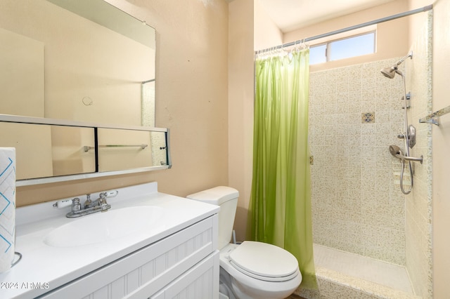 bathroom with curtained shower, vanity, and toilet