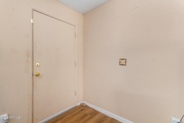 washroom featuring a textured ceiling and hardwood / wood-style flooring