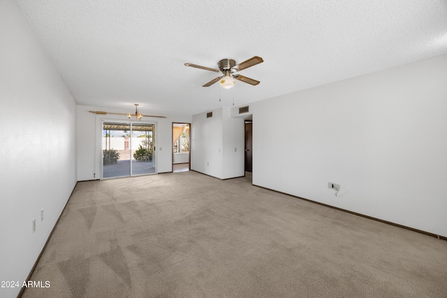 unfurnished living room featuring a textured ceiling, light colored carpet, and ceiling fan