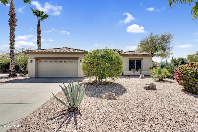 view of front of property featuring a tile roof, stucco siding, concrete driveway, and a garage