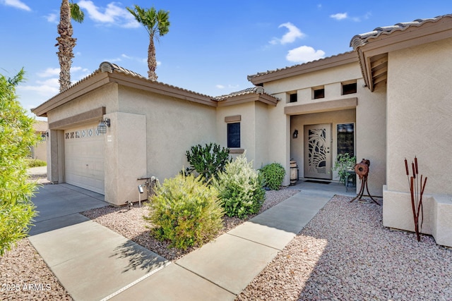 property entrance featuring stucco siding and an attached garage