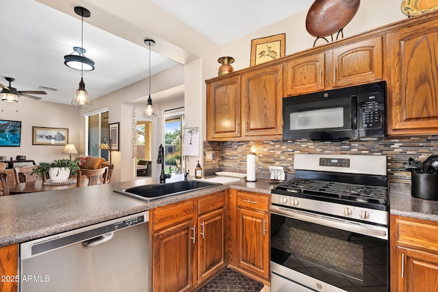 kitchen with a sink, a peninsula, backsplash, and stainless steel appliances