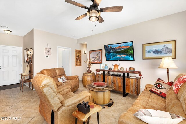 living room featuring light tile patterned flooring, visible vents, and ceiling fan