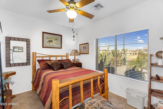 tiled bedroom with baseboards, visible vents, and ceiling fan