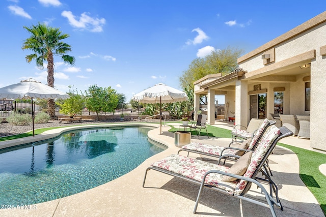 view of swimming pool with a patio area, a fenced in pool, and fence