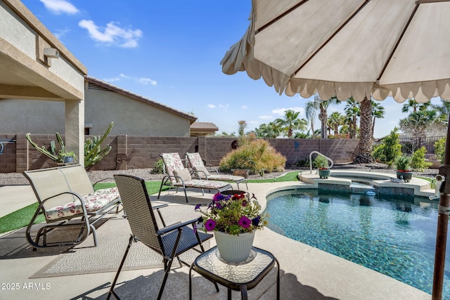 view of pool featuring a patio, a fenced backyard, and a pool with connected hot tub