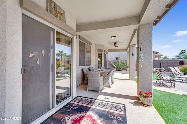 view of patio with a ceiling fan and fence