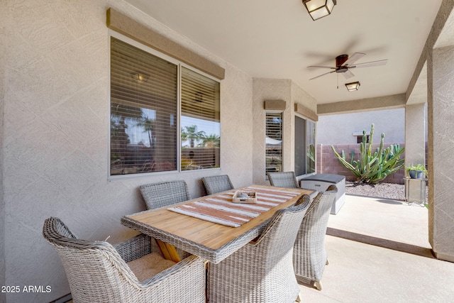 view of patio with outdoor dining area and ceiling fan