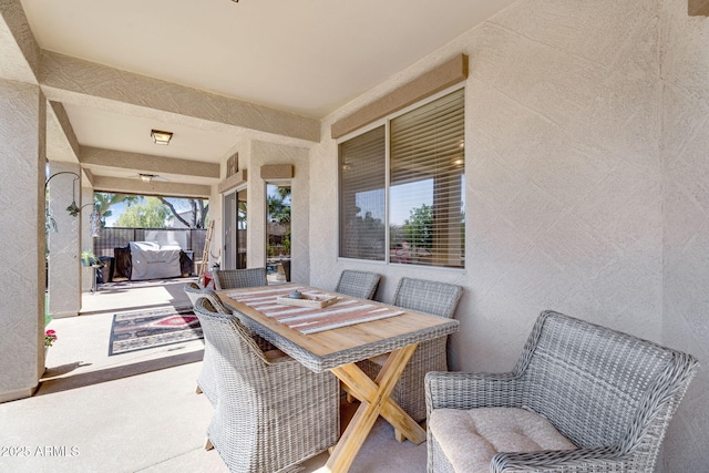 view of patio with outdoor dining area and fence