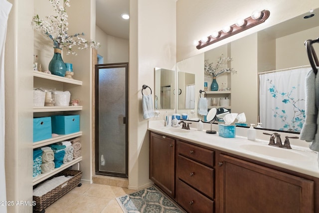 full bath featuring double vanity, a stall shower, tile patterned flooring, and a sink