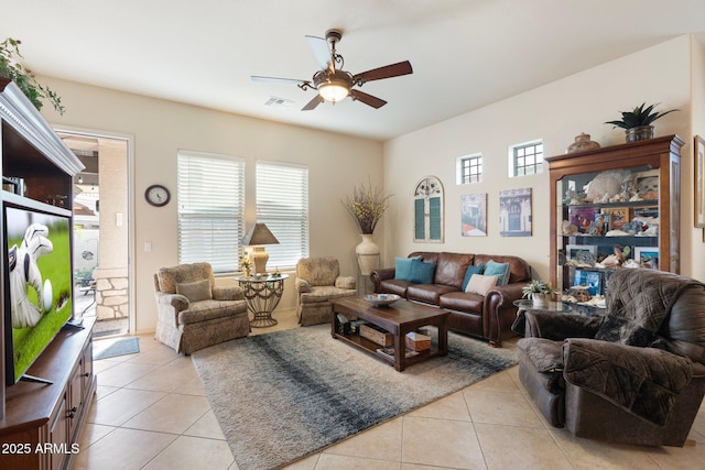 living room with visible vents, ceiling fan, and light tile patterned floors