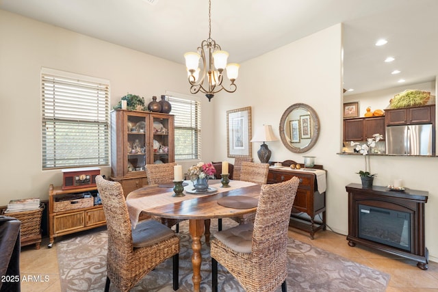 dining area featuring light tile patterned floors, a notable chandelier, and recessed lighting