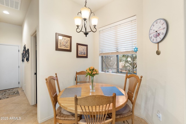 dining area with light tile patterned floors, visible vents, and a notable chandelier