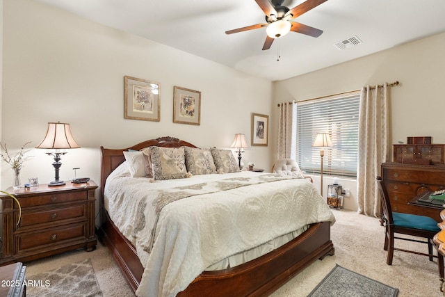 bedroom featuring a ceiling fan, light colored carpet, and visible vents