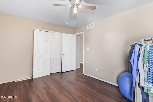 interior space with ceiling fan and dark hardwood / wood-style flooring