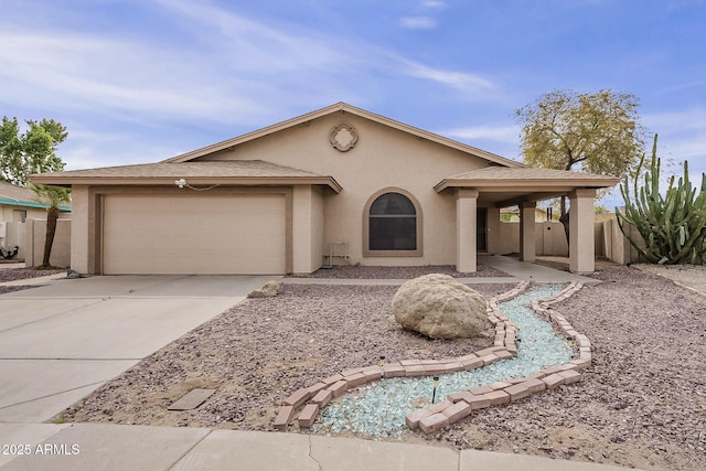 view of front of property with a garage, concrete driveway, fence, and stucco siding