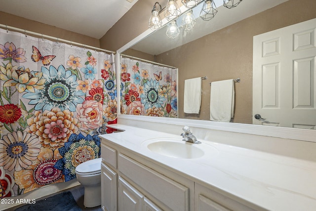 bathroom featuring toilet and vanity