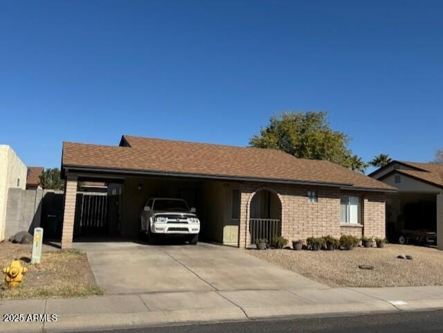 ranch-style house featuring a carport