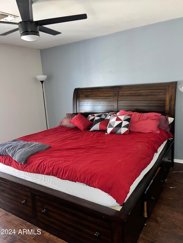 bedroom with dark wood-type flooring and ceiling fan